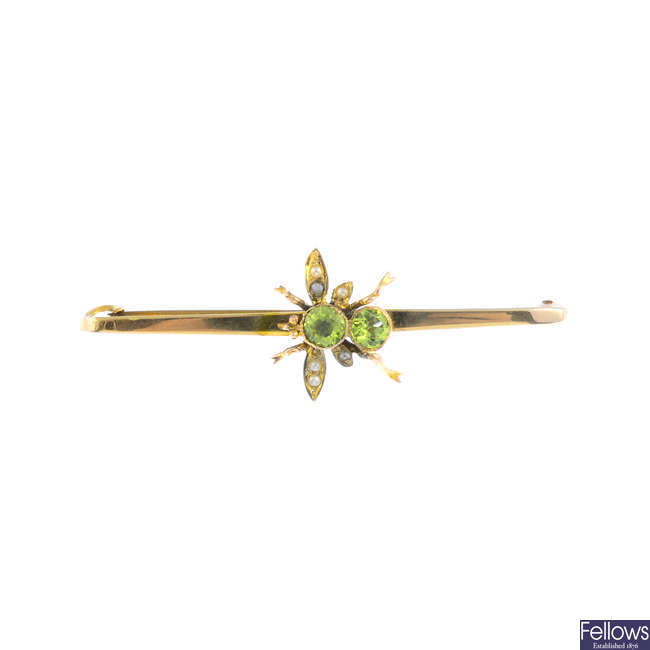 An early 20th century gold peridot and imitation pearl insect brooch.