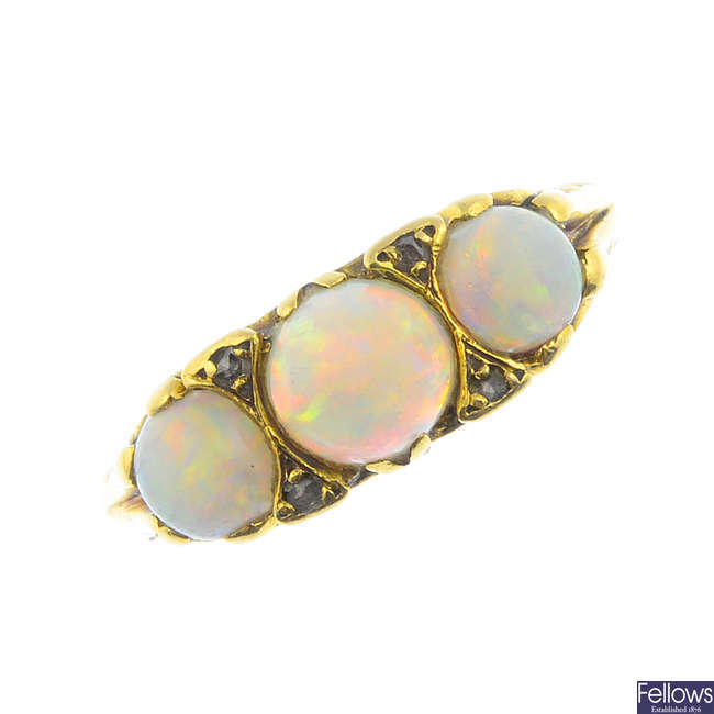 An early 20th century 18ct gold opal three-stone and diamond ring.