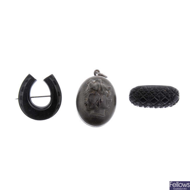 Four items of jet jewellery and a vulcanite locket.