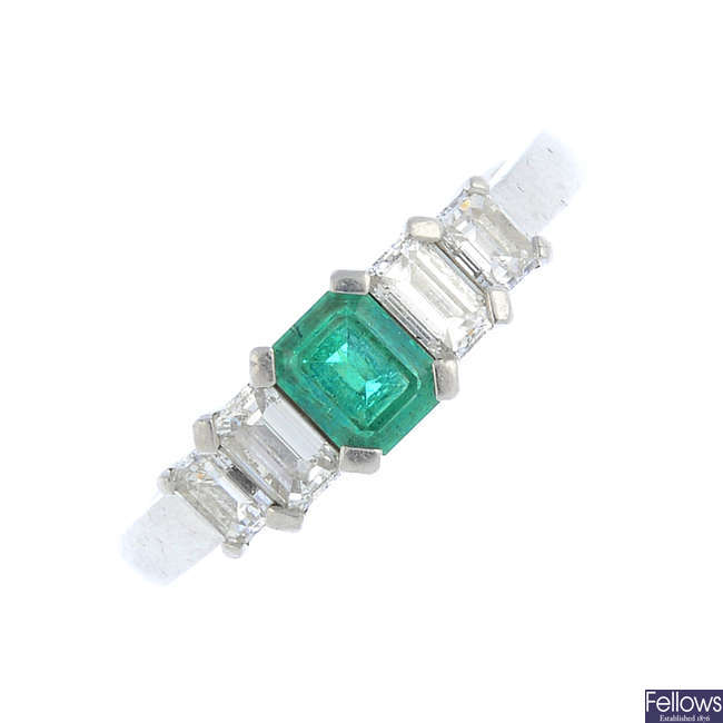 A platinum emerald and diamond dress ring.