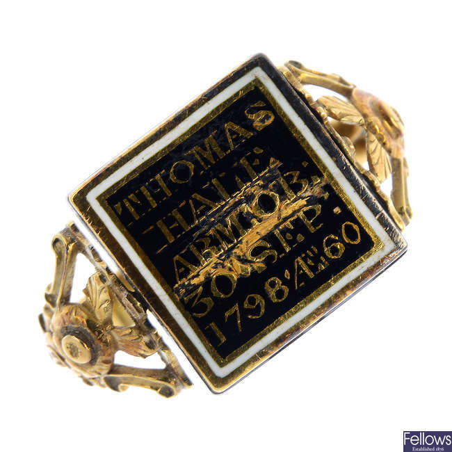 A late Georgian silver and gold diamond and enamel swivel mourning ring.
