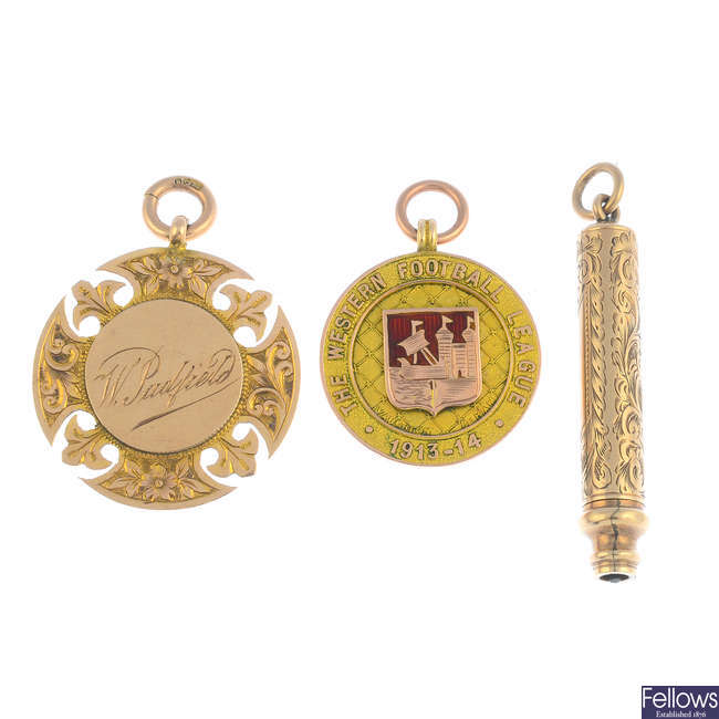 Two early 20th century 9ct gold medals and a retractable pencil.