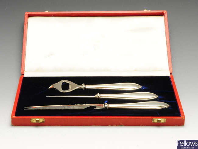 An American silver-handled three piece drinks set in Cartier case.  