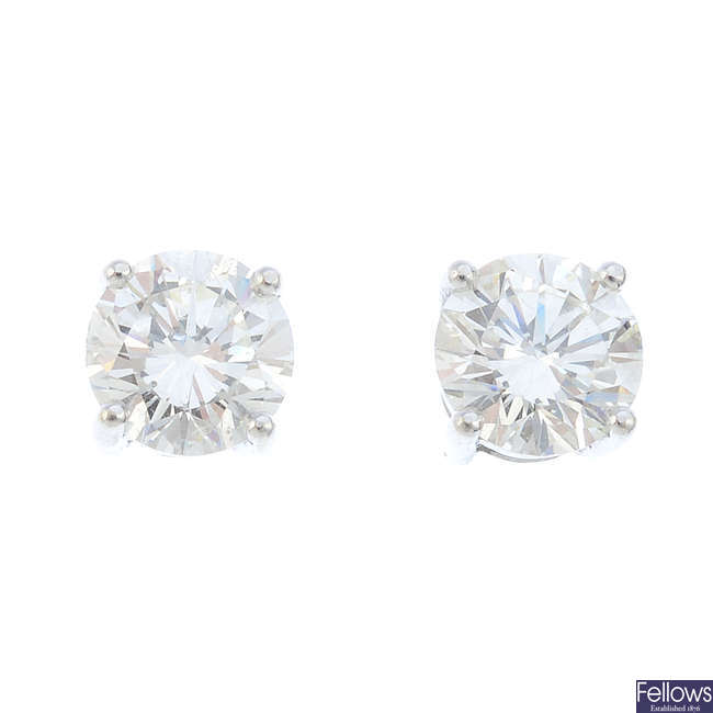 A pair of brilliant-cut diamond stud earrings.
