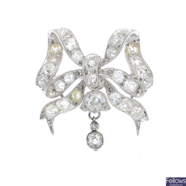 A diamond bow brooch.