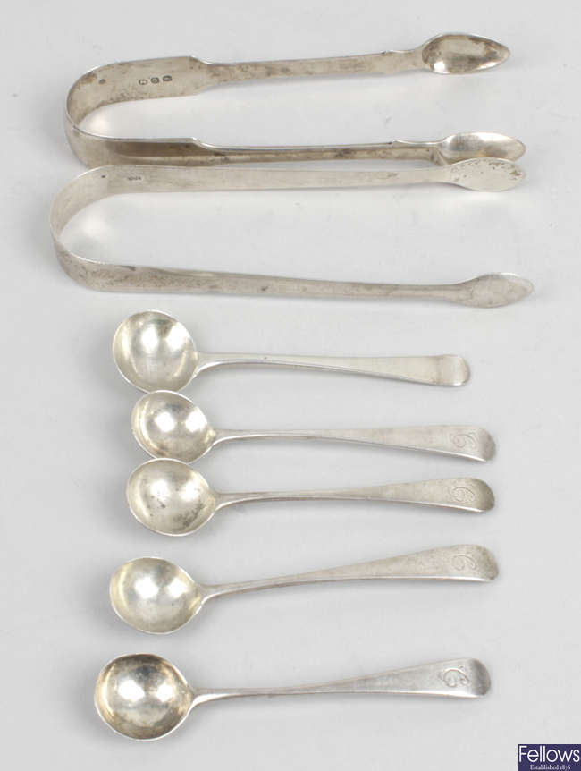 Two pairs of Georgian silver sugar tongs & five salt/mustard spoons.
