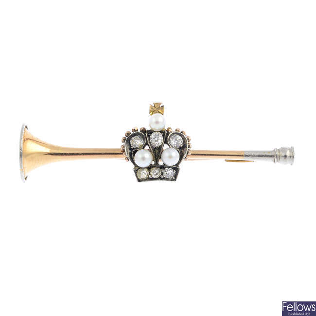 An early 20th century gold and platinum seed pearl and diamond trumpet brooch.