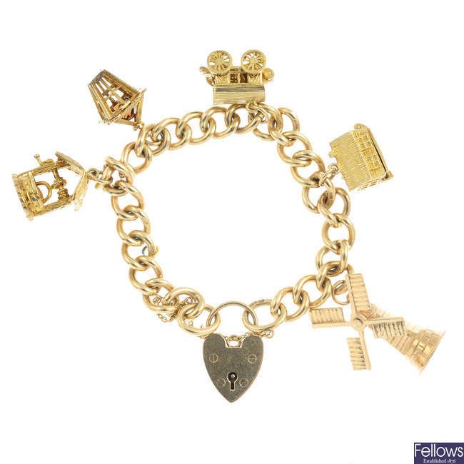 A 1970s 9ct gold charm bracelet with five charms.