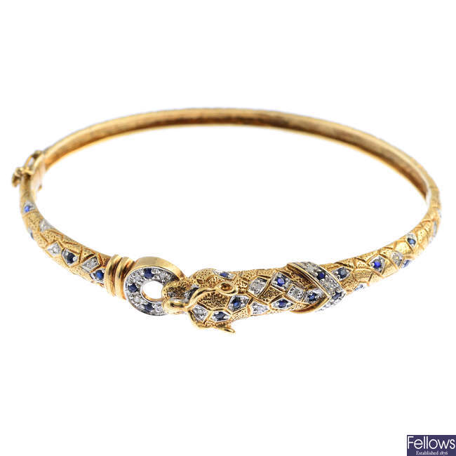 A 9ct gold sapphire and diamond leopard hinged bangle.