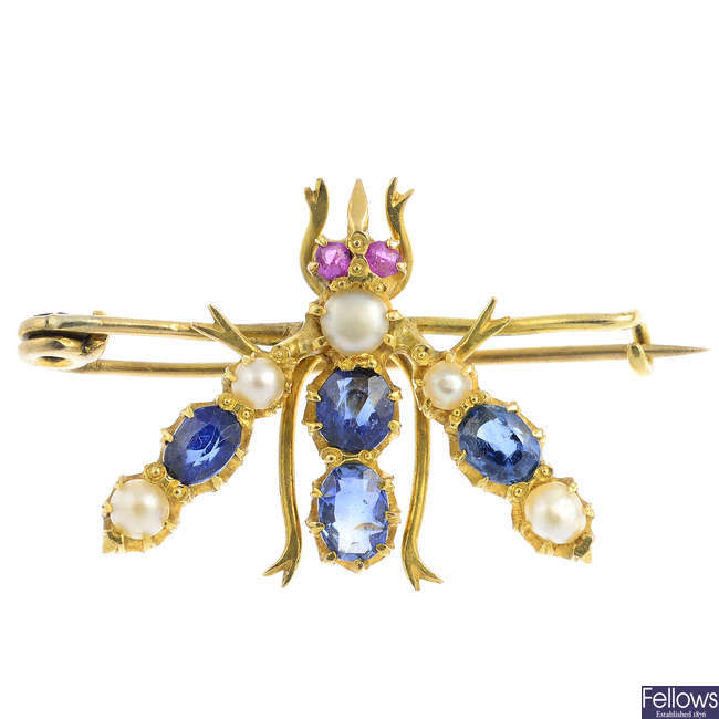 An early 20th century gold, sapphire, split pearl and ruby fly brooch.