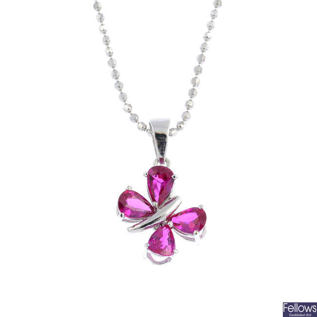 An 18ct gold ruby butterfly pendant, with chain.