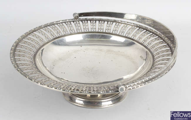 An early 20th century silver pierced footed dish with swing handle.