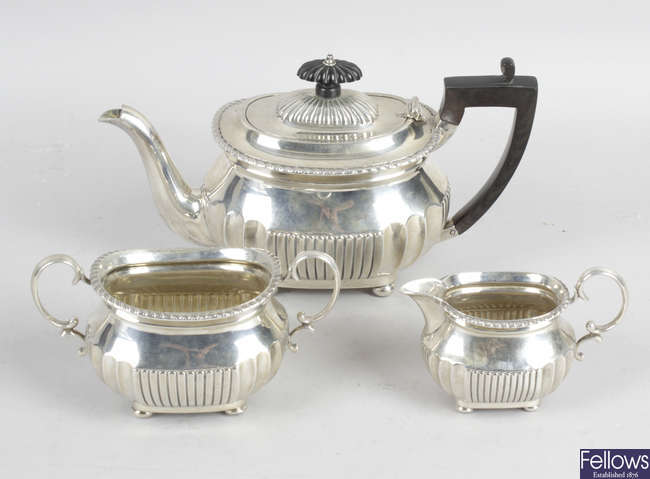 A late Victorian silver three piece bachelor tea set.