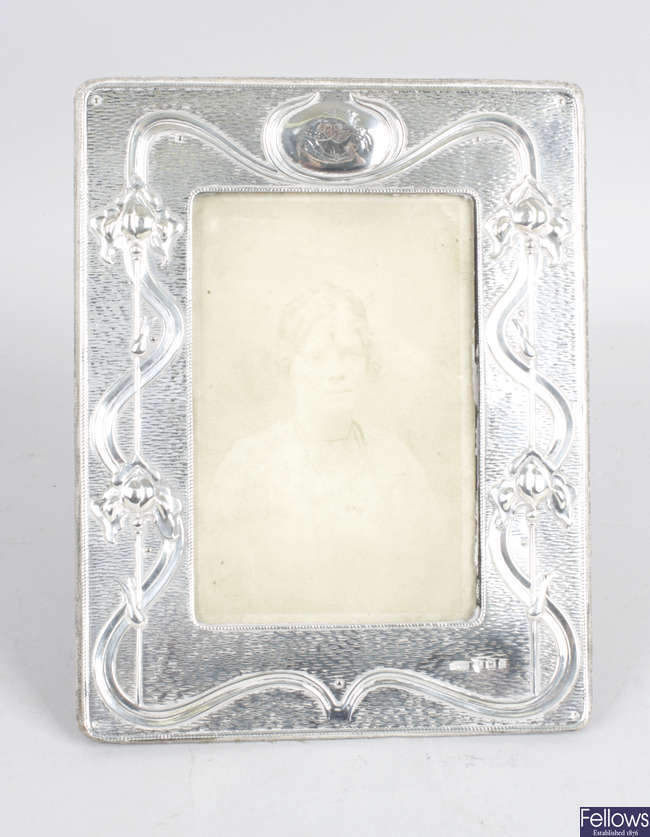 An Edwardian Art Nouveau silver mounted photograph frame. 
