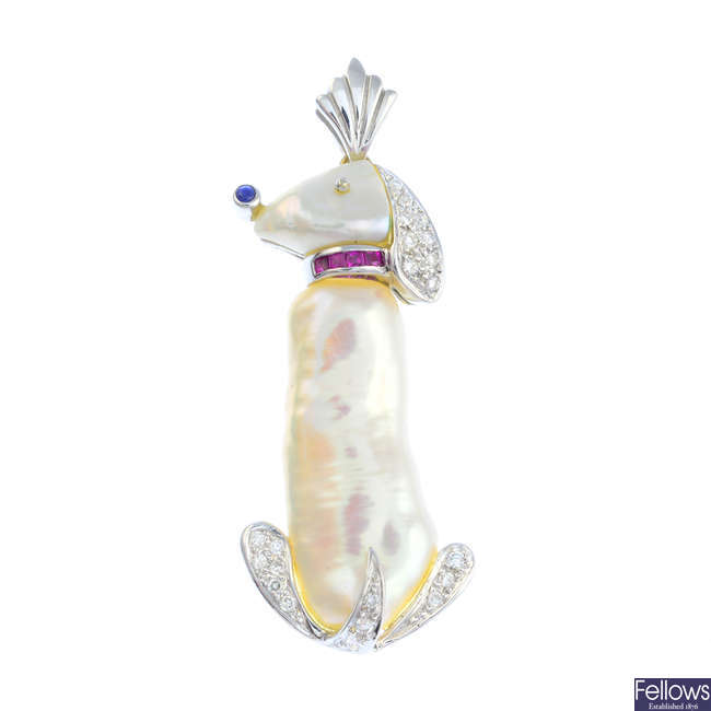 A baroque cultured pearl, diamond, ruby and sapphire dog pendant.