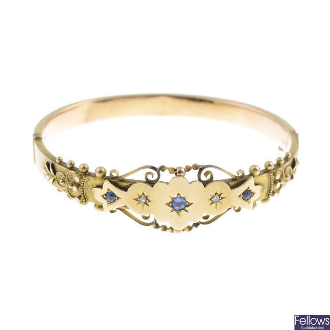 An Edwardian 9ct gold paste and diamond hinged bangle.