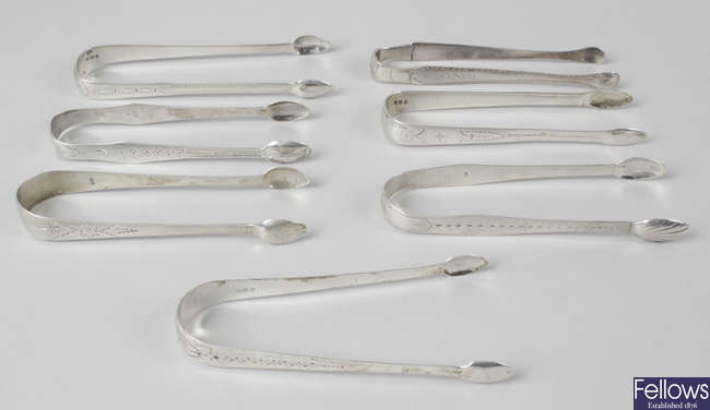 Six pairs of George III silver sugar tongs, bright cut engraved, plus an unmarked pair. (a.f). (7). 