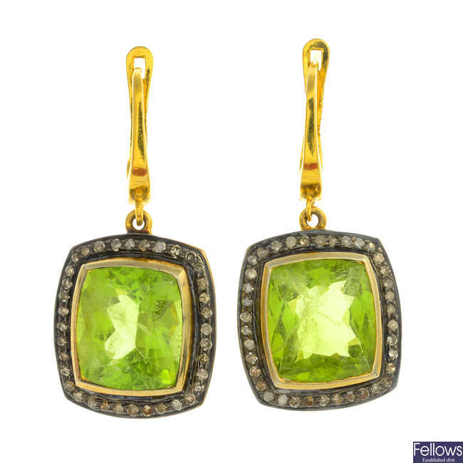 A pair of peridot and diamond earrings.