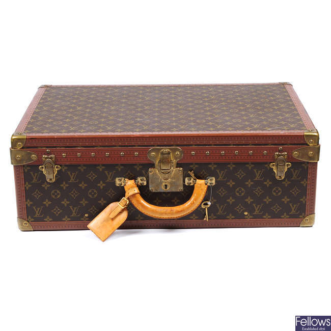 LOUIS VUITTON - a Monogram Alzer 65 hard suitcase.