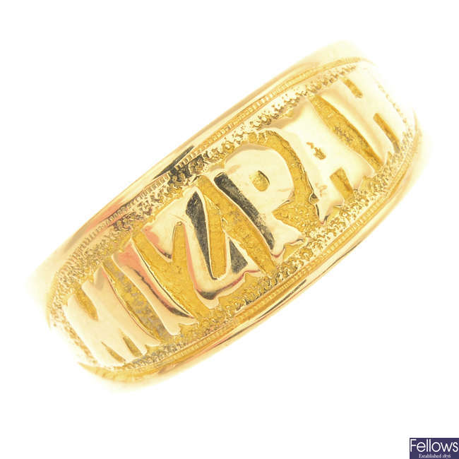 An Edwardian 18ct gold band ring.