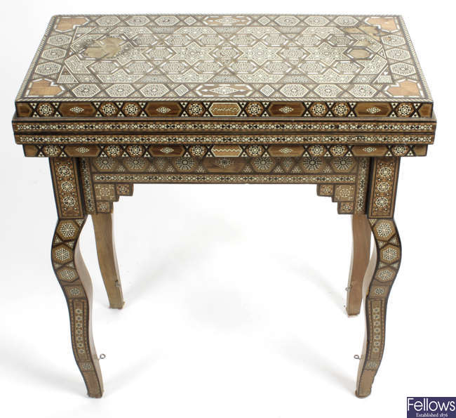 A late 19th century Anglo Indian ivory and mother of pearl inlaid hardwood games table.