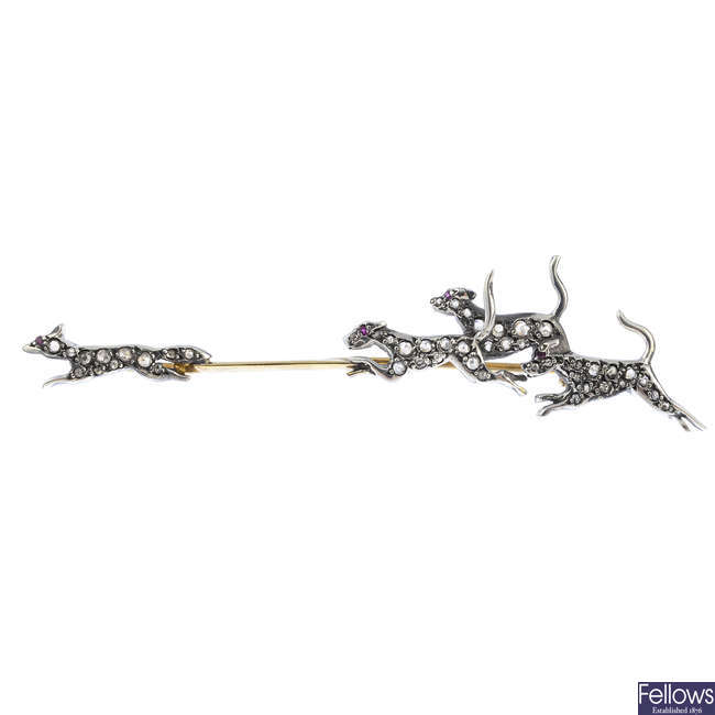 A diamond and gem-set fox and hounds' brooch.