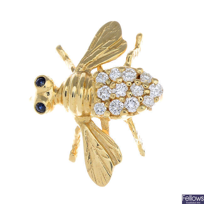 A diamond and sapphire bee brooch.