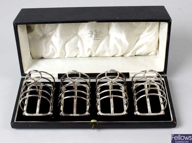 A 1930's cased set of four small silver toast racks.