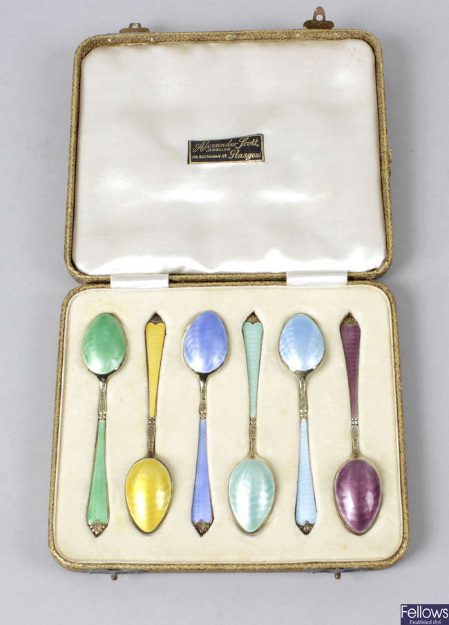 A 1930's cased set of six silver & enamel coffee spoons.