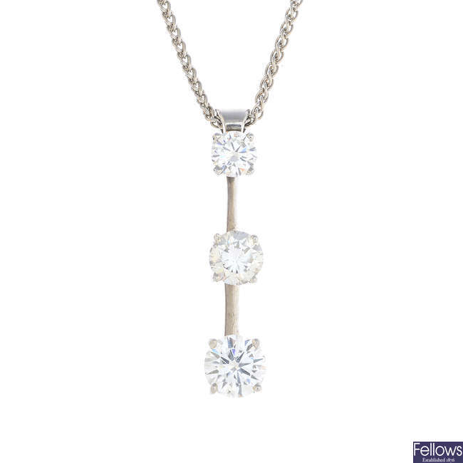 A diamond three-stone pendant, with chain.