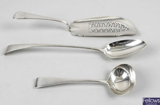 A George IV silver fish slice, a George III basting spoon, two 'berry' spoons & a Victorian sauce ladle & butter knife. (6).
