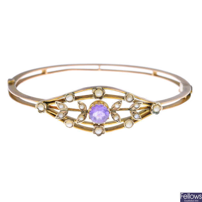 An early 20th century 9ct gold amethyst and split pearl bangle.