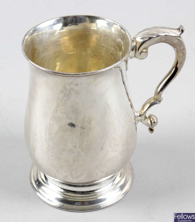 A George III silver baluster pint mug.