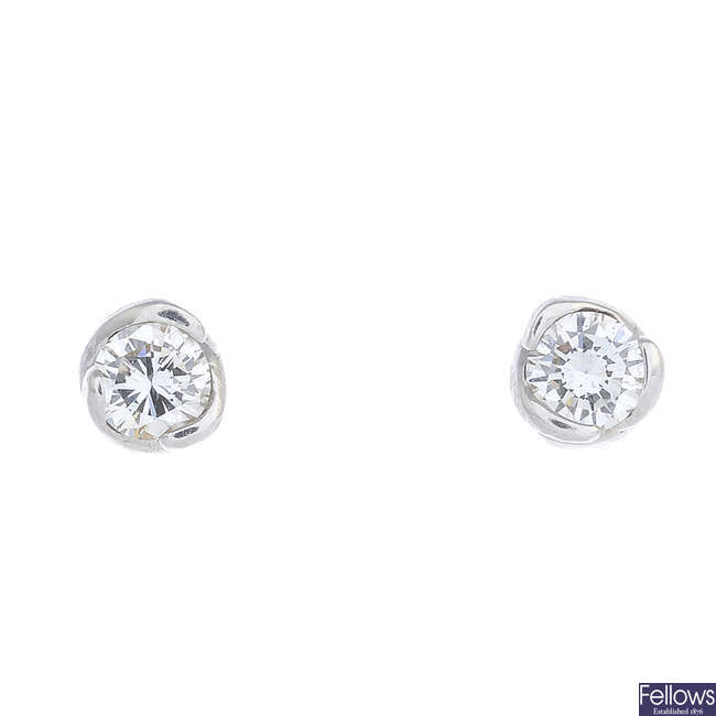 A pair of diamond single-stone earrings.