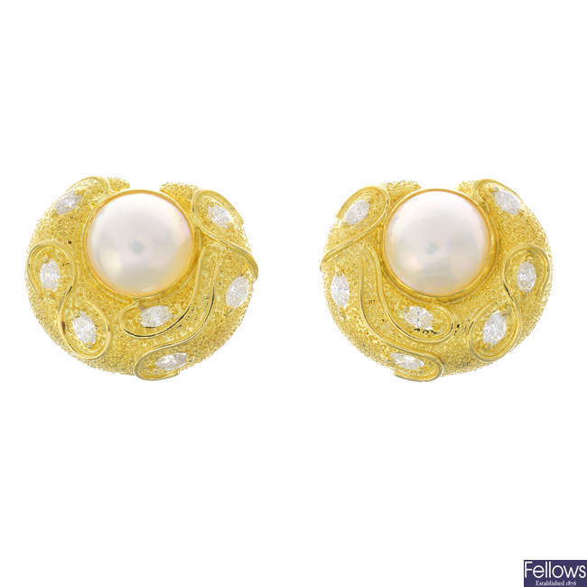 A pair of mabe pearl diamond earrings.