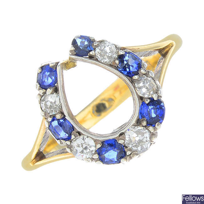 A diamond and sapphire horseshoe ring.