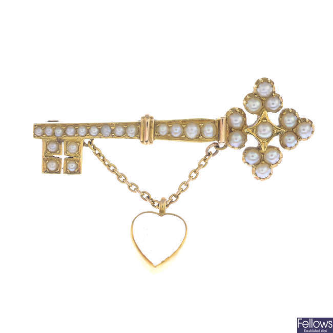 An early 20th century split pearl and moonstone key brooch.