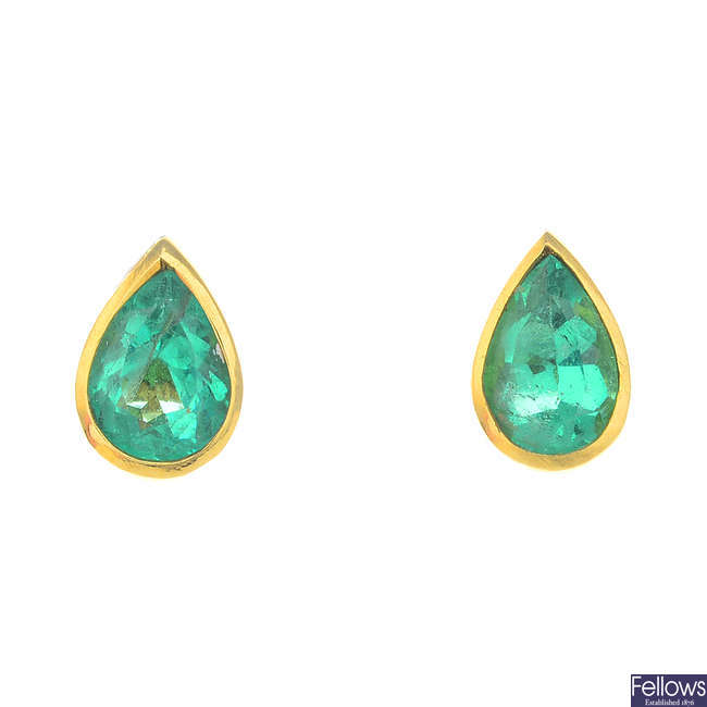 A pair of emerald earrings.