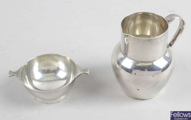 A 1920's small Scottish silver quaich, plus a small silver cream jug. (2). 
