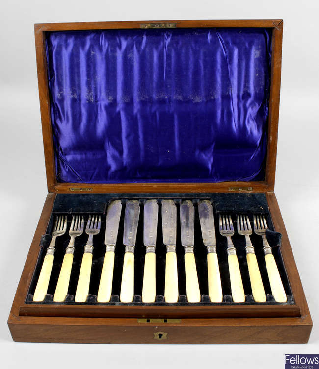 A cased set of Edwardian silver and ivory-handled fish knives and forks & a further cased set of fruit knives and forks.