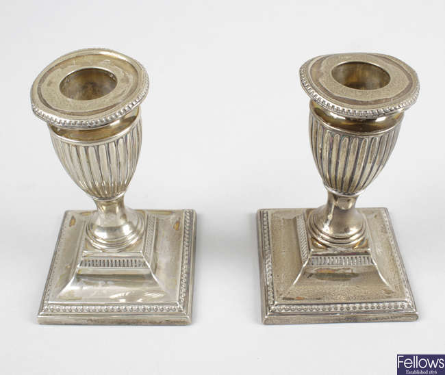 A pair of Edwardian silver mounted dwarf candlesticks.