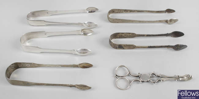 A pair of Georgian silver scissor action sugar nips, plus five pairs of George III sugar tongs. (6).