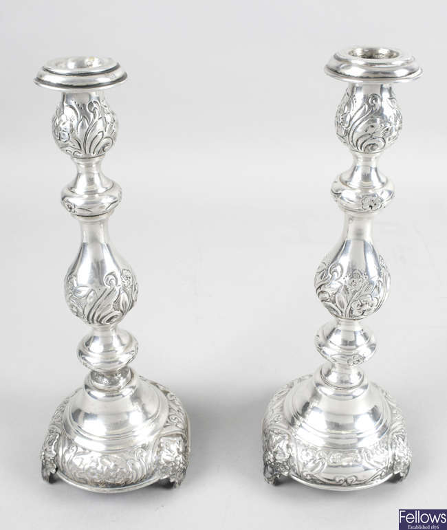 A pair of early George V silver candlesticks.