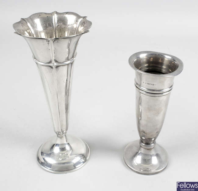 A George V silver trumpet vase (filled base), plus a later, smaller example. (2). 