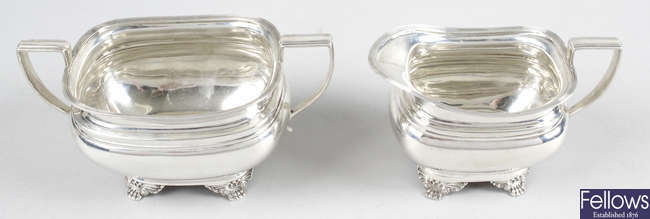 A 1920's silver twin-handled sugar bowl & a matching cream jug. (2).