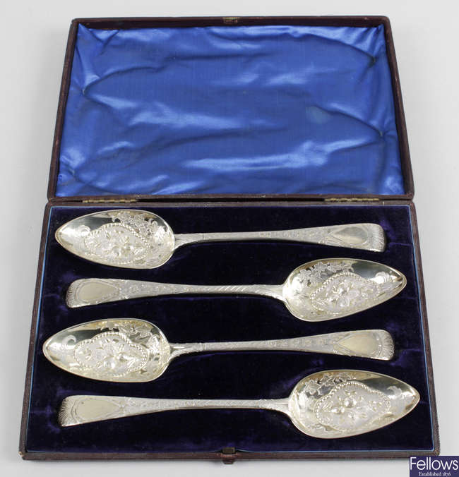 A cased set of four George III silver-gilt 'berry' spoons. 