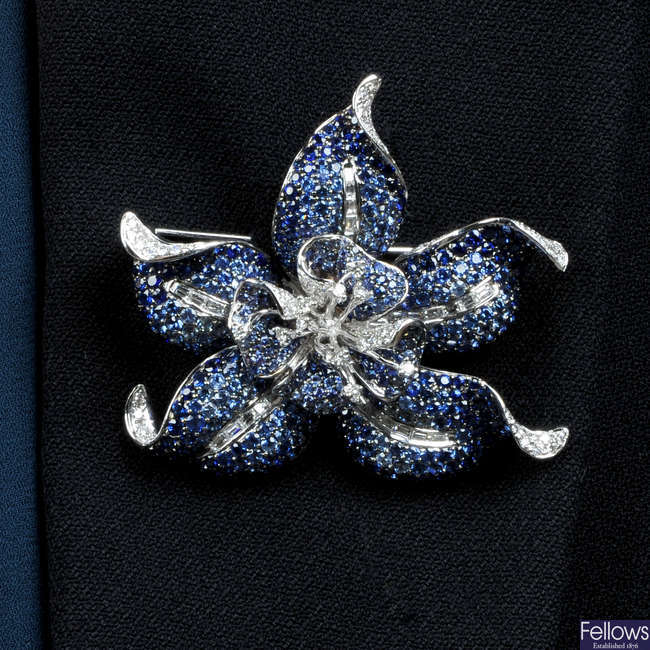 A sapphire and diamond flower brooch.