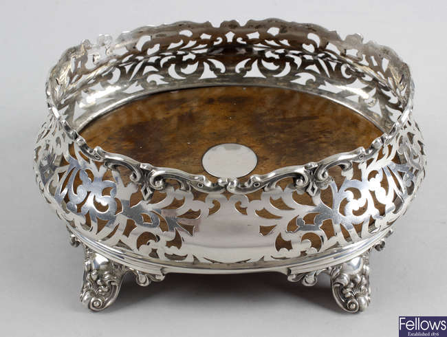 A Victorian silver mounted oval coaster, plus two pierced baskets. (3). 