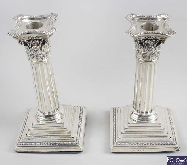 A pair of late Victorian silver mounted Corinthian column candlesticks.