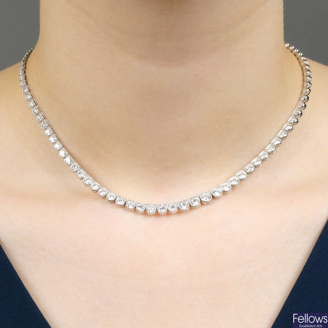 A graduated brilliant-cut diamond line necklace.